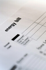 Finance and business concept. On a brown background lies a calculator and dollars on a clip with an inscription on paper - Energy bill