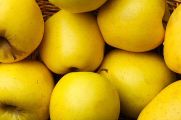 Fresh juicy yellow apples in basket, closeup