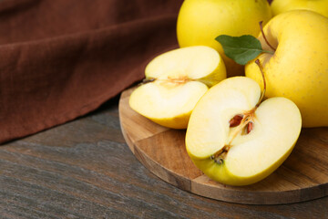 Fresh ripe yellow apples on wooden table, closeup. Space for text