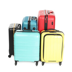 Many closed colorful suitcases isolated on white