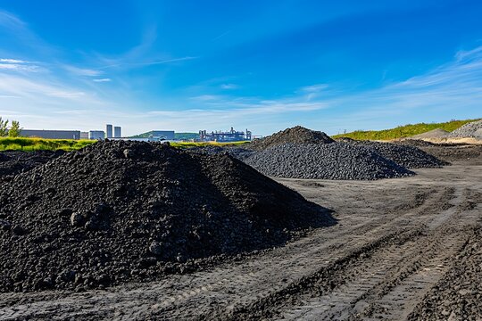 Large piles of coal and slag dominating industrial landscape