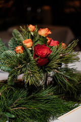 flower arrangement with roses and fir branches
