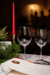 table setting in a restaurant. Glasses and candle on a festive table