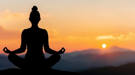 A woman is meditating in a beautiful mountain setting