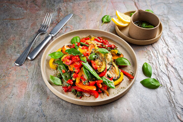 French style summer ratatouille salad with roasted vegetables served as closeup with vinaigrette balsamic dressing on a design plate