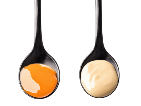 Isolated Spoons with Yellow and White Sauces