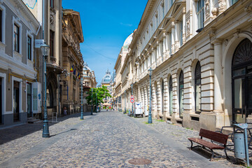 Street view of Old town in Bucharest, with old buildings and a paved road.