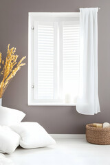 Cozy room interior with window, shutters, pillows, and dried flowers.  Use Home decor inspiration, interior design