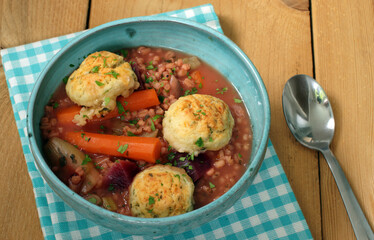 vegetable stew with dumplings in blue bowl