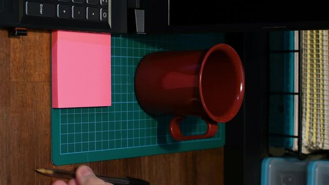 Office setting laptop man&rsquo;s hand arranging note pad pen on desk Obsessive Compulsive Disorder ritual OCD concept vertical video