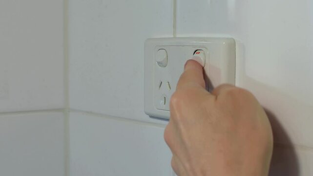 240 volt power point outlet man&rsquo;s hand unplugging lead cord repeatedly switching switch off and on and off Obsessive Compulsive Disorder OCD concept 