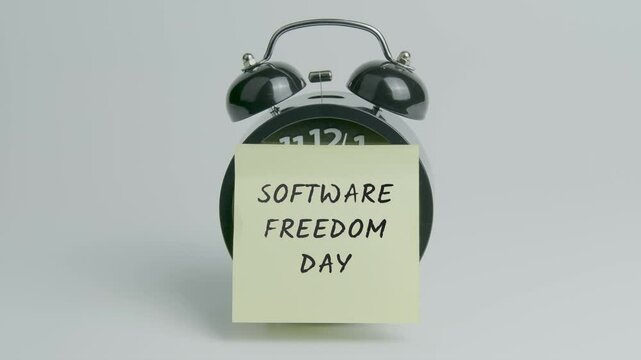 Software Freedom Day Text or Word on Yellow Note Paper Sticking onto Black Alarm Clock on White Background With Sound