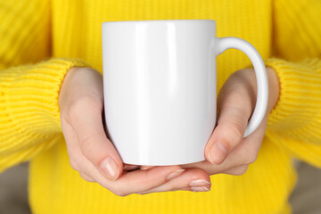 Woman with white ceramic cup, closeup. Mockup for design