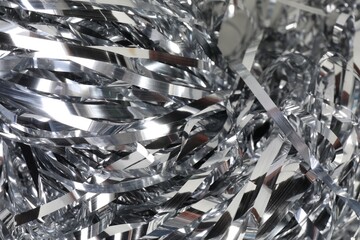 Shiny silver tinsel as background, closeup view