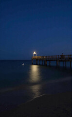 Fototapeta premium pier at night, sea, sunset, pier, water, beach, ocean, sky, sunrise, landscape, bridge, sun, night, nature, dusk, lake, clouds, jetty, coast, travel, summer, river, evening, calm, horizon, wooden