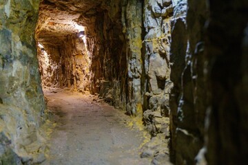Venture into the dark and winding underground mine tunnel. A unique adventure awaits those brave enough to explore its mysterious depths and uncover the secrets within.