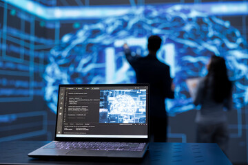 Focus on laptop used by engineers in blurry background to use AI cognitive computing. Close up shot...