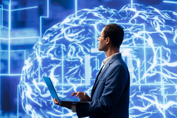 Computer scientist analyzes AI models with large digital brain displayed behind. IT specialist in...