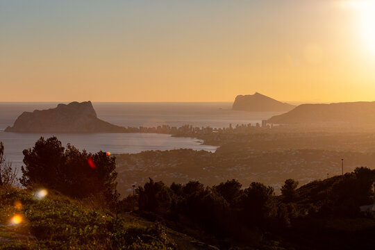 View of Penyal d Ifac Natural Park and small resort town Moraira at sunset from the top of the mountain Puig de la llorenca