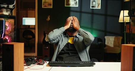 Upset african american man frustrated after losing online competitive multiplayer match playing on...