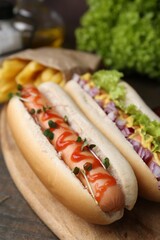 Tasty hot dogs served on wooden table, closeup