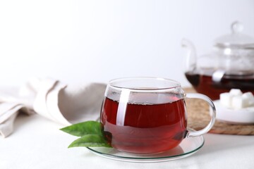 Refreshing black tea in cup on light table