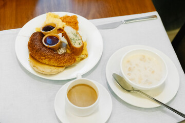 Plate full of food at breakfast, all-inclusive concept, hotel breakfast, caloric food, carbohydrates
