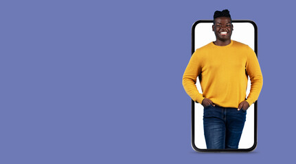 A person stands confidently with hands in pockets, displayed on a large smartphone screen. This representation highlights modern communication through technology.