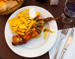 Appetizing roasted rabbit with potatoes and parsley