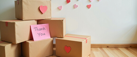 Boxes of donated goods stacked in festive corner