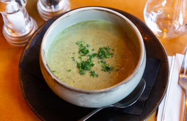 Light healthy vegetable puree soup for lunch served with chopped fresh greens. Vegetarian concept..