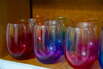 multi-colored crystal wine glasses on the shelf