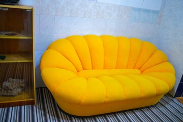Stylish interior of living room with yellow sofa