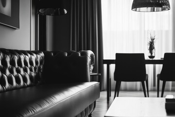 Obraz premium A stylish living room with leather sofa, chairs at a wooden table. Modern decor with black and white color scheme.