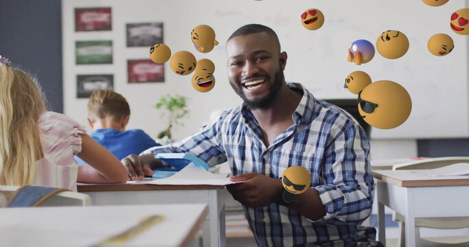 Image of emoji icons over diverse schoolchildren and teacher - Powered by Adobe