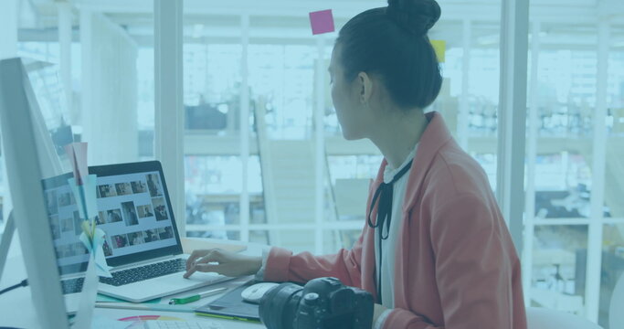 Image of charts processing data over biracial female creative using camera at office