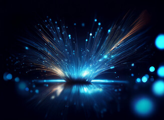 Fototapeta premium A vibrant burst of light, radiating outwards in streaks of blue, orange, and white, reflects on a dark, glossy surface. The light creates a captivating, dynamic display against the black background.