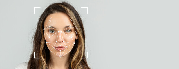 A woman is featured with facial recognition markers superimposed on her face. This technology...