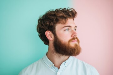 Obraz premium Stylish Young Man with Curly Hair and Beard Against a Colorful Background