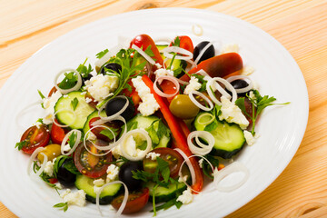 Traditional dish of Balkan cuisine salad with fresh vegetables, brynza cheese and onion