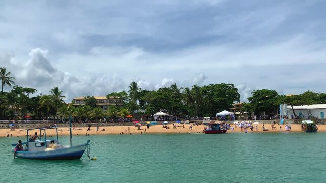People on the beach and in boats to celebrate Iemanj&aacute; day in Bahia. Celebration of the orix&aacute; queen of the sea.