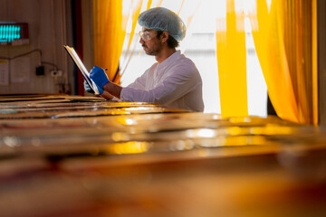 Industrial inspector performing a quality check on warehouse products Focus on safety precision and...