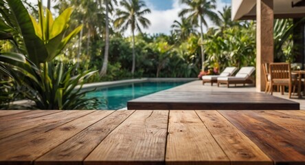 Empty wood table top on a tropical home terrace setting with a blurred background. The focus is on the table surface.