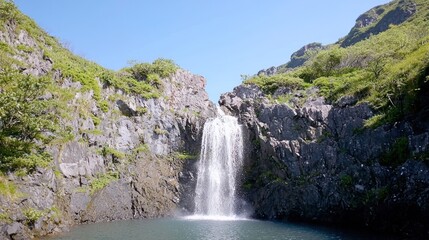 Obraz premium Refreshing Waterfall in Mountain Landscape