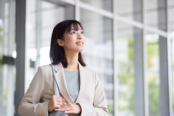 オフィスから出発する日本人ビジネスウーマン