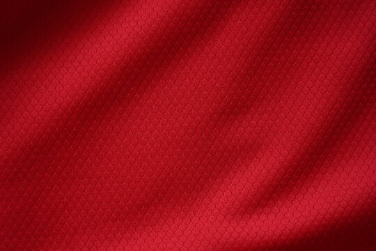 Close up of red football jersey sports clothing fabric texture.