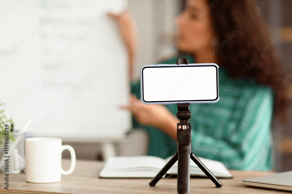 Poster modern remote education. lady teacher shooting video lecture on smartphone using tripod having confe