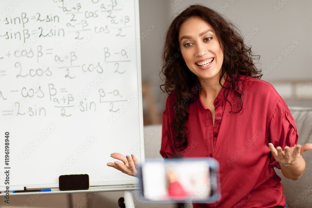 Poster smiling lady sitting in front of smartphone on stabilizer, recording video or having live videoconfe