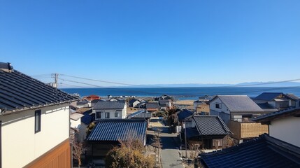 Fototapeta premium Coastal View of Houses and Beach on a Clear Day with Blue Sky