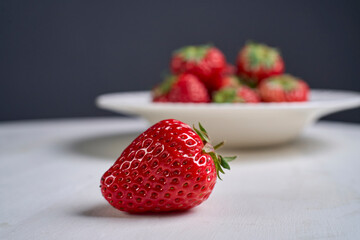 fresh strawberries in white porcelain plate